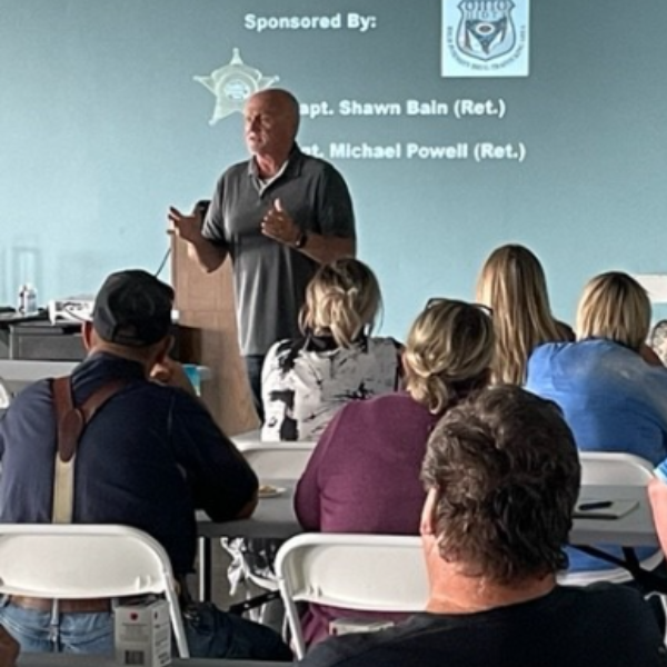 a man speaking to a crowd of people